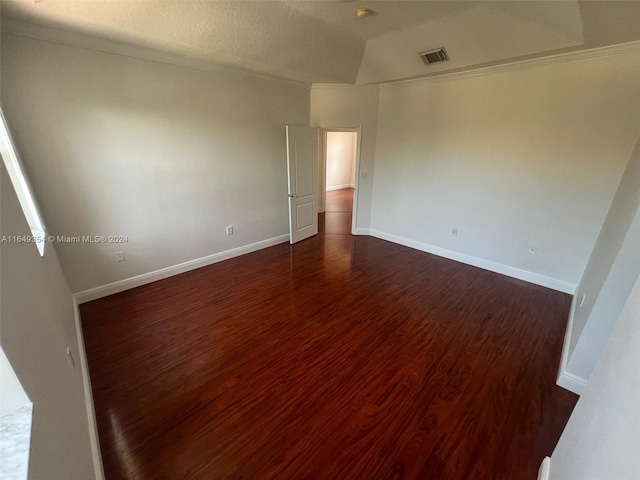 spare room with dark hardwood / wood-style floors