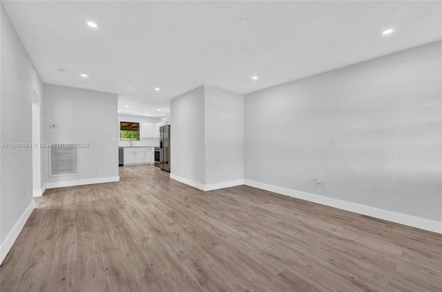 unfurnished living room with light wood-type flooring