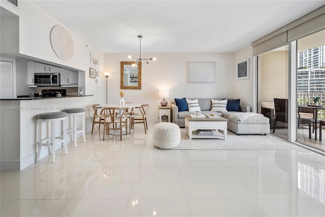 tiled living room featuring an inviting chandelier