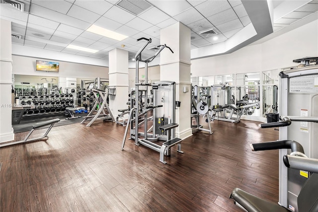 workout area with hardwood / wood-style floors and a paneled ceiling