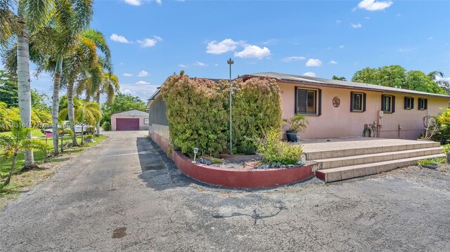 view of front of property featuring a garage and an outdoor structure