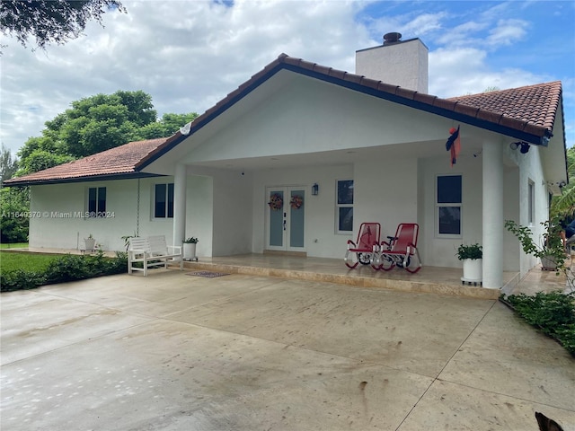 24490 SW 120th Ave, Homestead, FL 33032 - back of property featuring a tile roof, a chimney, french doors, and stucco siding