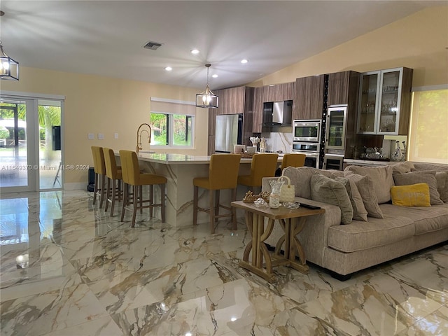 24490 SW 120th Ave, Homestead, FL 33032 - living area featuring light marble finish flooring, lofted ceiling, recessed lighting, and wine cooler