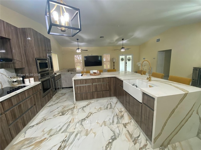 24490 SW 120th Ave, Homestead, FL 33032 - kitchen with a sink, open floor plan, light marble finish flooring, black electric cooktop, and modern cabinets