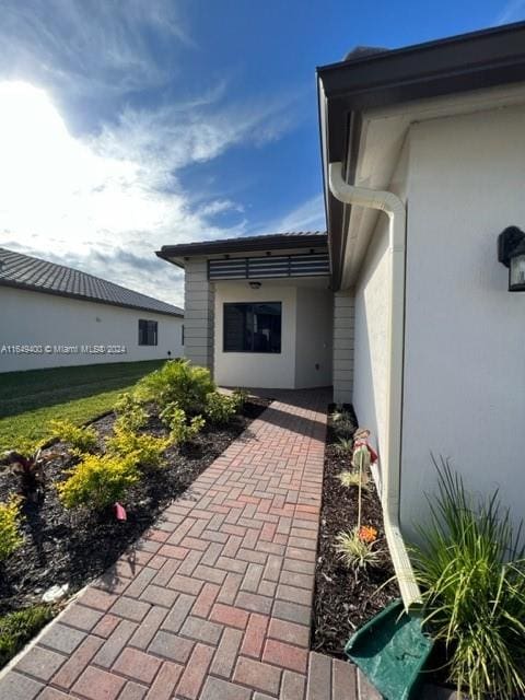 doorway to property with a yard