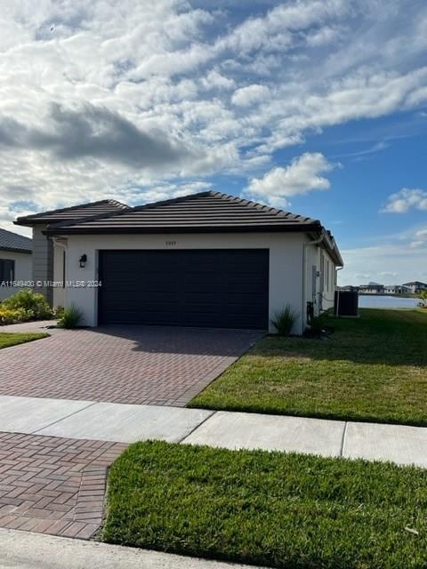 single story home with a front yard and a garage