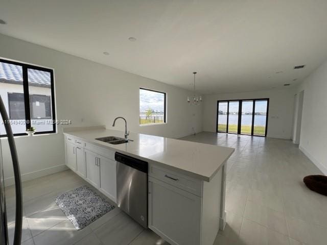 kitchen featuring a wealth of natural light, dishwasher, kitchen peninsula, and sink