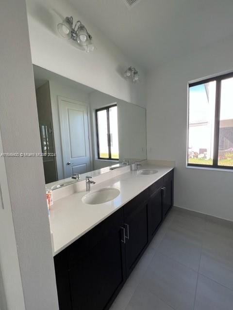 bathroom with tile patterned floors and vanity