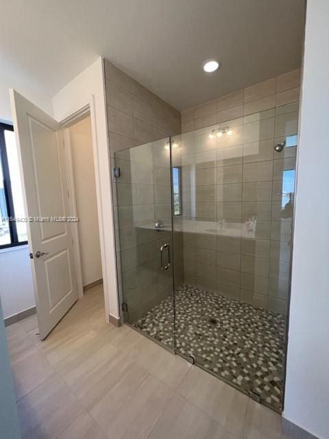 bathroom with a shower with door