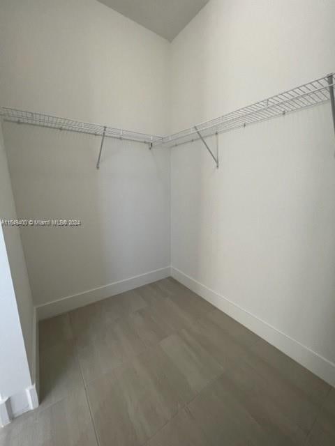 spacious closet featuring hardwood / wood-style floors