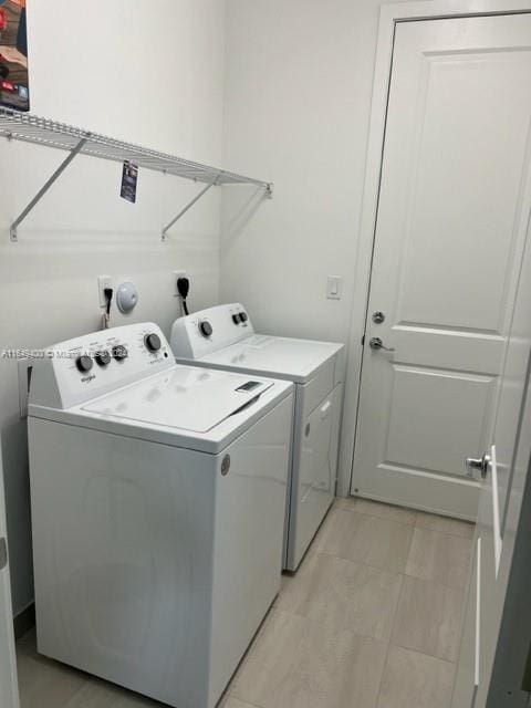 washroom with washing machine and clothes dryer