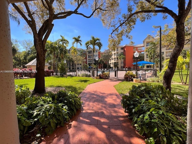 view of property's community with a yard