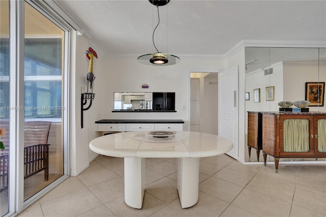 tiled dining space featuring a textured ceiling and ornamental molding