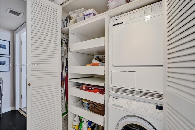 laundry room featuring stacked washer and clothes dryer