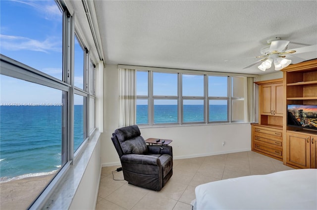 bedroom featuring multiple windows, ceiling fan, and light tile patterned floors