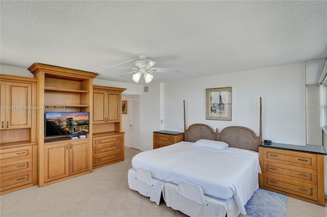 tiled bedroom featuring ceiling fan and a textured ceiling