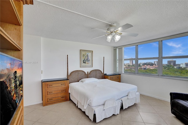 tiled bedroom featuring a textured ceiling and ceiling fan