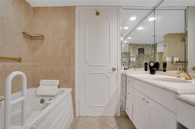 bathroom with tile patterned flooring, vanity, independent shower and bath, and tile walls