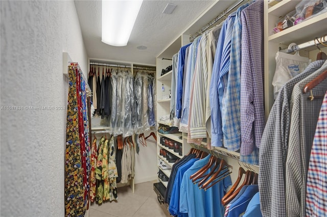 walk in closet with light tile patterned floors