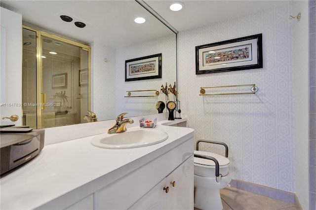 bathroom with tile patterned flooring, vanity, toilet, and a shower with shower door