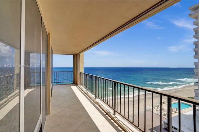 balcony with a view of the beach and a water view