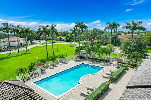 view of pool with a lawn and a patio area