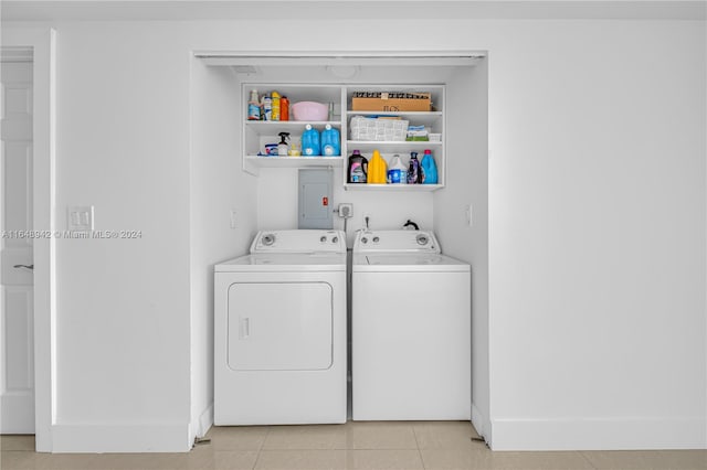 clothes washing area with light tile patterned floors and washing machine and clothes dryer