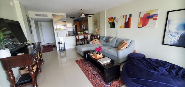 tiled living room featuring ceiling fan