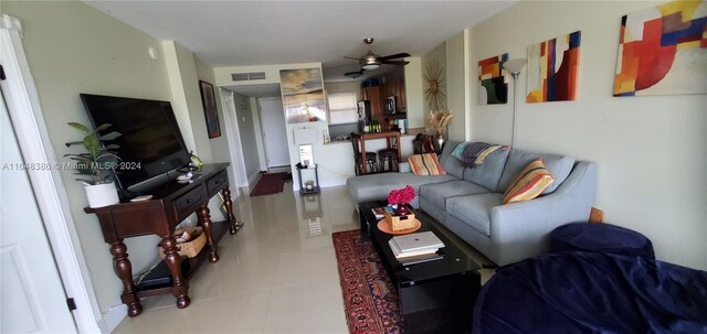 living room with ceiling fan and tile patterned floors