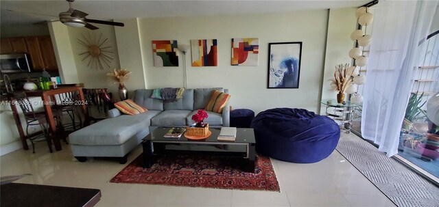 living room with ceiling fan and tile patterned flooring