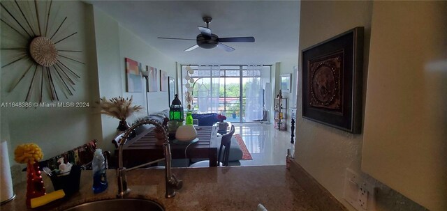 dining room with ceiling fan and sink