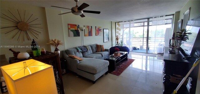 living room featuring a wealth of natural light, ceiling fan, and tile patterned floors