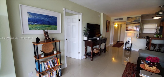 tiled living room with ceiling fan