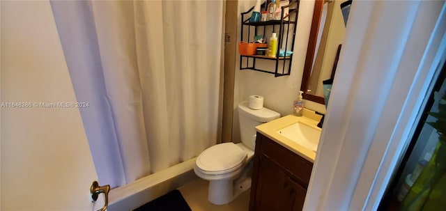 bathroom featuring vanity, toilet, and curtained shower