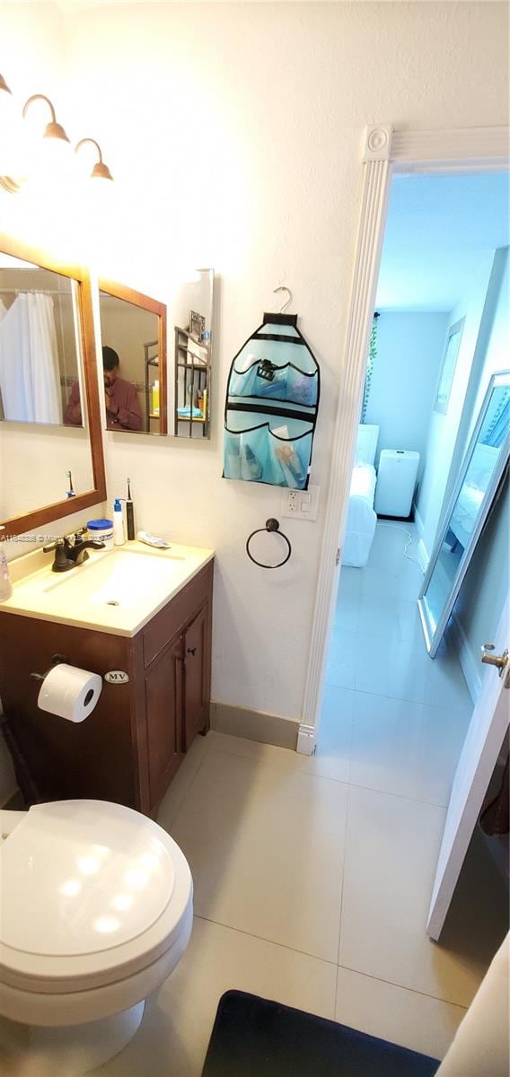 bathroom featuring vanity, toilet, and tile patterned floors