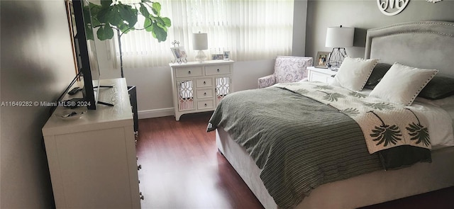 bedroom with dark wood-type flooring