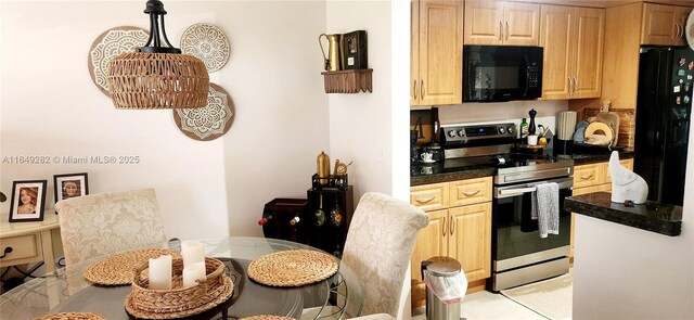 kitchen featuring black appliances and light brown cabinetry