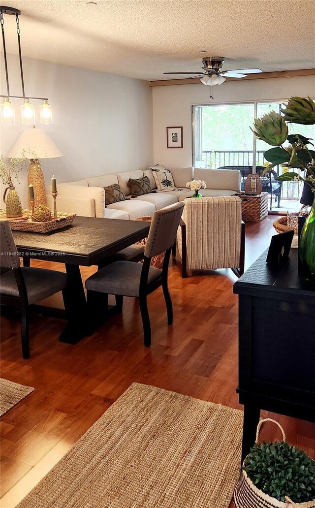 dining space with a textured ceiling, hardwood / wood-style floors, and ceiling fan