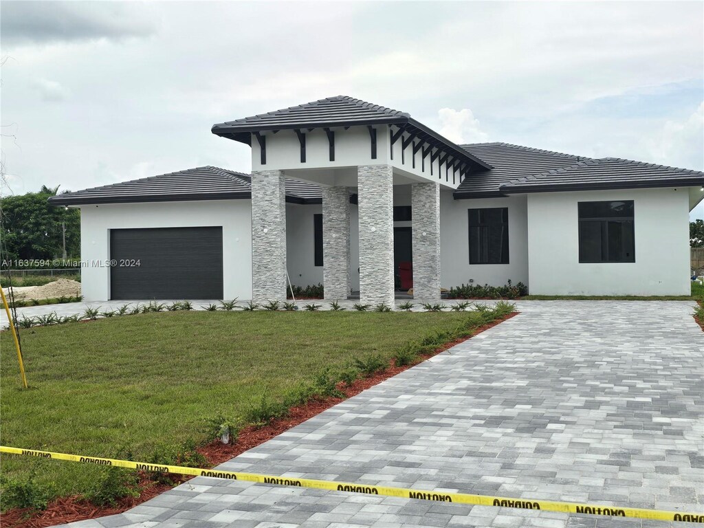 prairie-style house with a front lawn and a garage