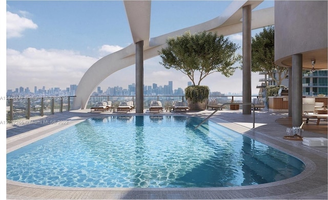 community pool featuring a view of city and a patio