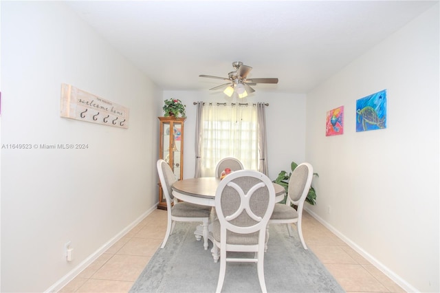 dining space with ceiling fan and light tile patterned flooring