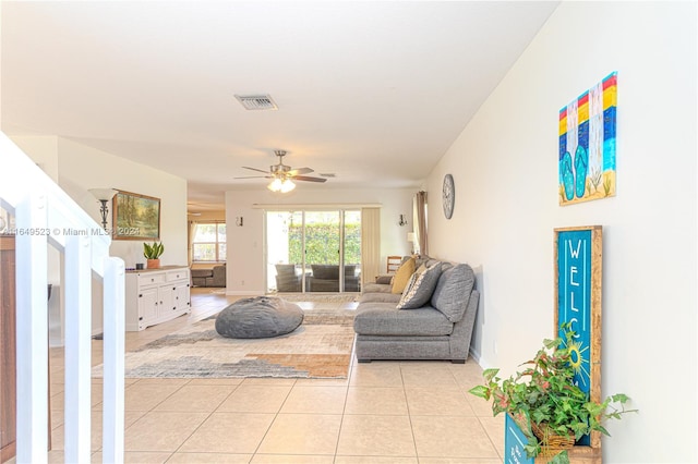 tiled living room featuring ceiling fan