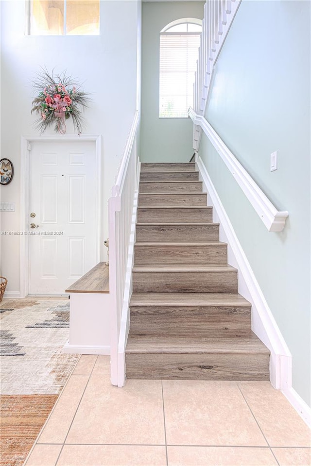 stairs with tile patterned floors