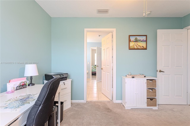 office with light carpet and a textured ceiling