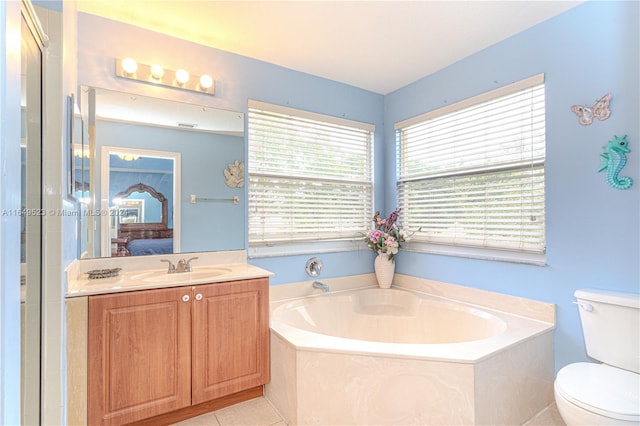 bathroom with vanity, toilet, tile patterned floors, and a washtub