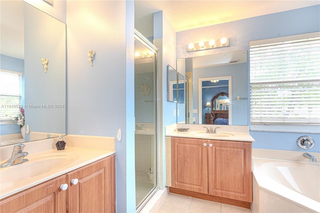 bathroom featuring tile patterned flooring, vanity, and separate shower and tub