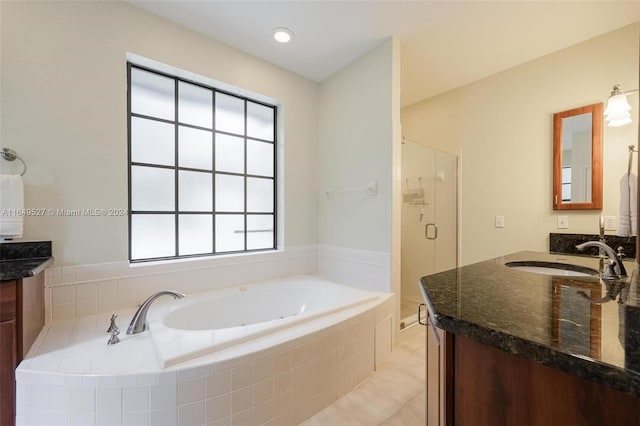 bathroom featuring tile patterned floors, a healthy amount of sunlight, shower with separate bathtub, and vanity