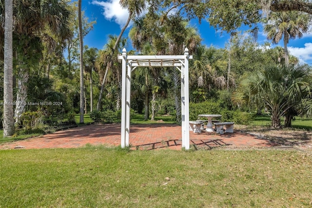 view of home's community featuring a yard and a patio