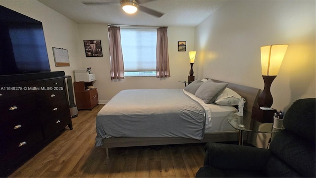 bedroom with hardwood / wood-style floors and ceiling fan