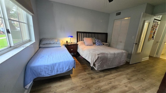 bedroom with hardwood / wood-style flooring and ceiling fan